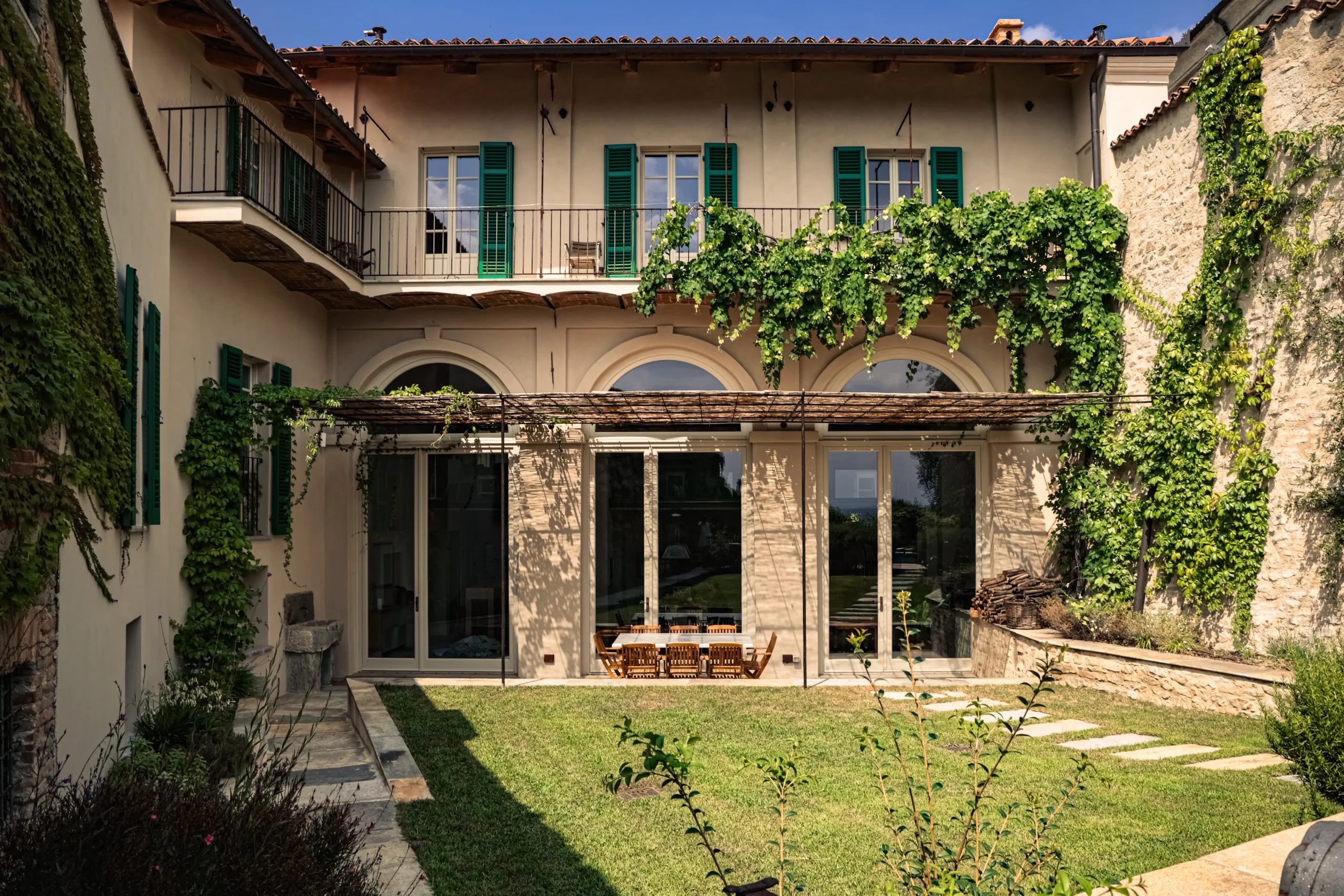 MON's outdoor courtyard with stone facade and vines